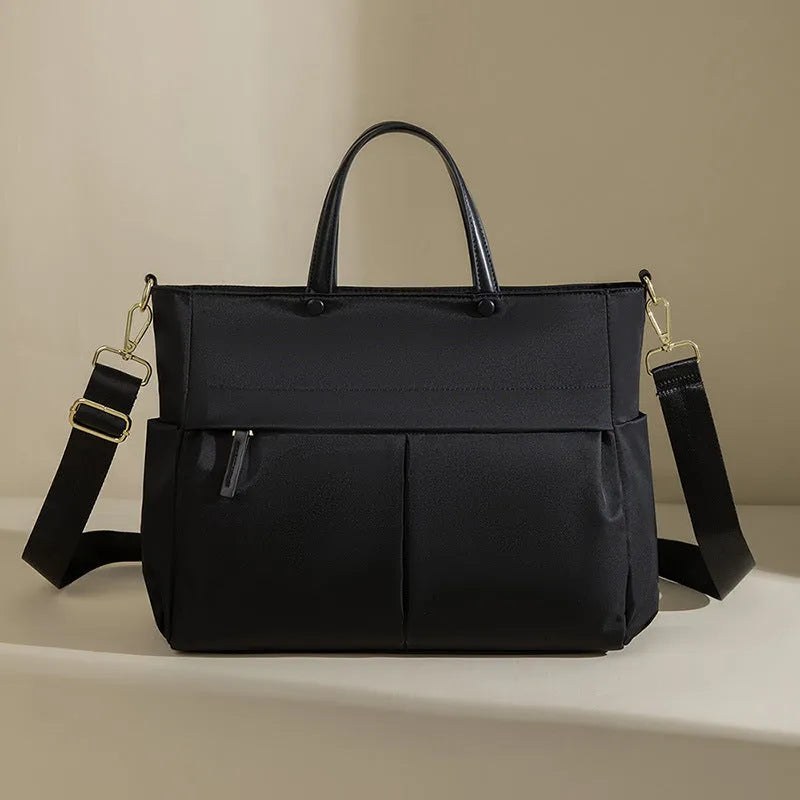 Women's Oxford cloth laptop briefcase showing elegant black colour with multiple open pockets and portable handle