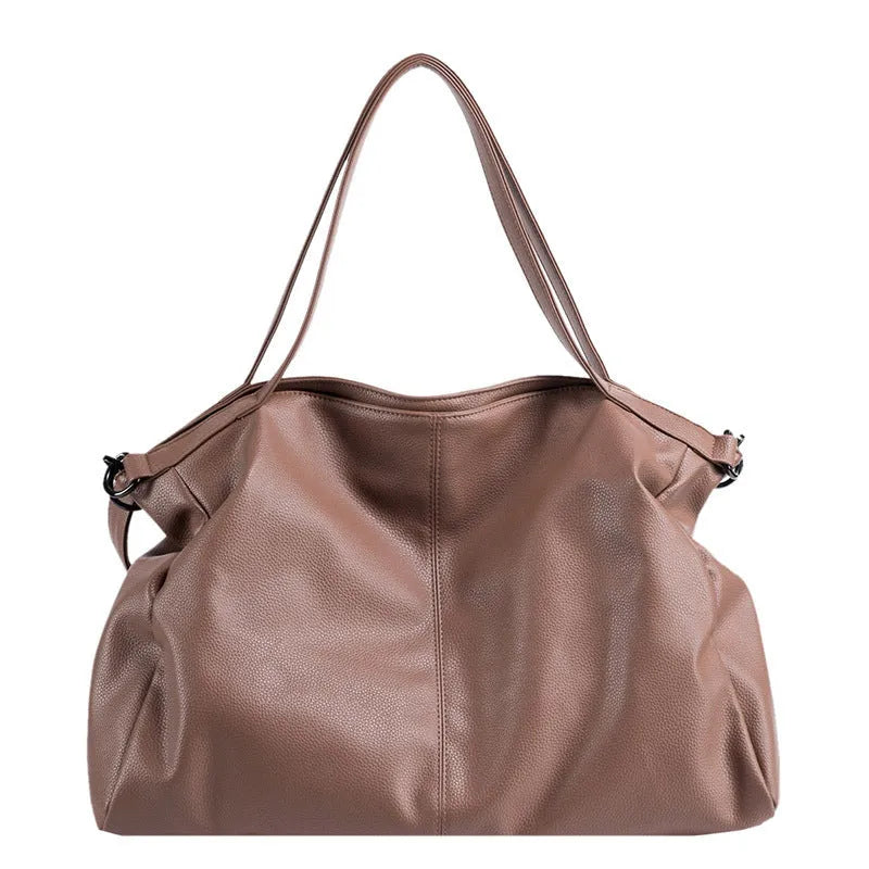 Large soft surface PU messenger bag in horizontal square shape with shoulder strap and top handle.