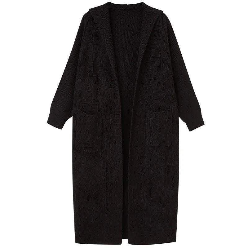 Long grey knitted cardigan coat with a hood and regular sleeves on a model.