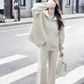 Solid colour knitted zipper cardigan and wide leg trousers two-piece set in polyester fabric.
