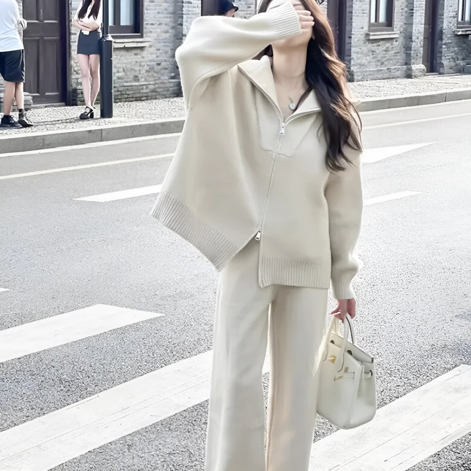 Solid colour knitted zipper cardigan and wide leg trousers two-piece set in polyester fabric.