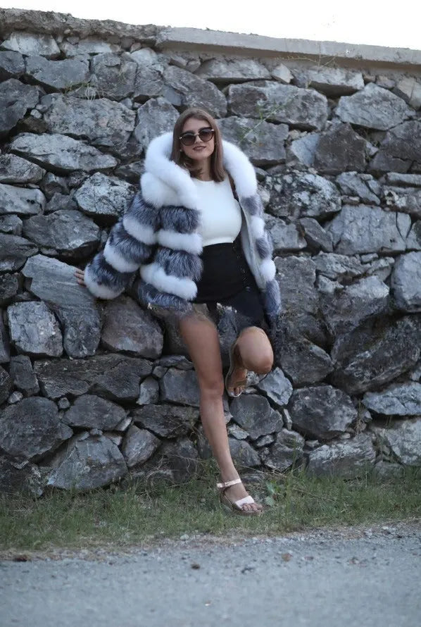 Women's loose faux fur hooded coat in street style, shown in medium length
