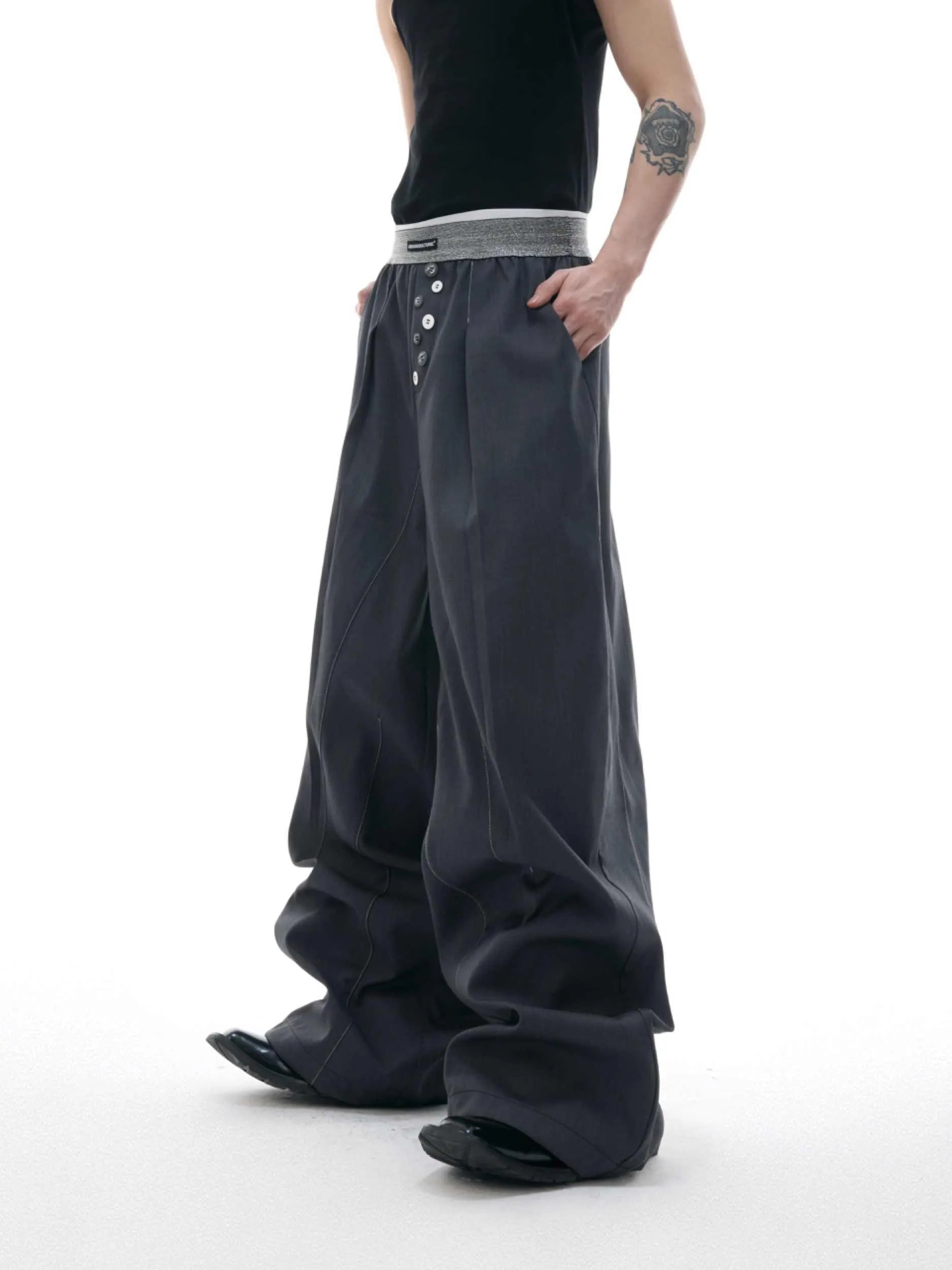 Drooping straight-leg high-waisted casual trousers with button detail in black and grey.