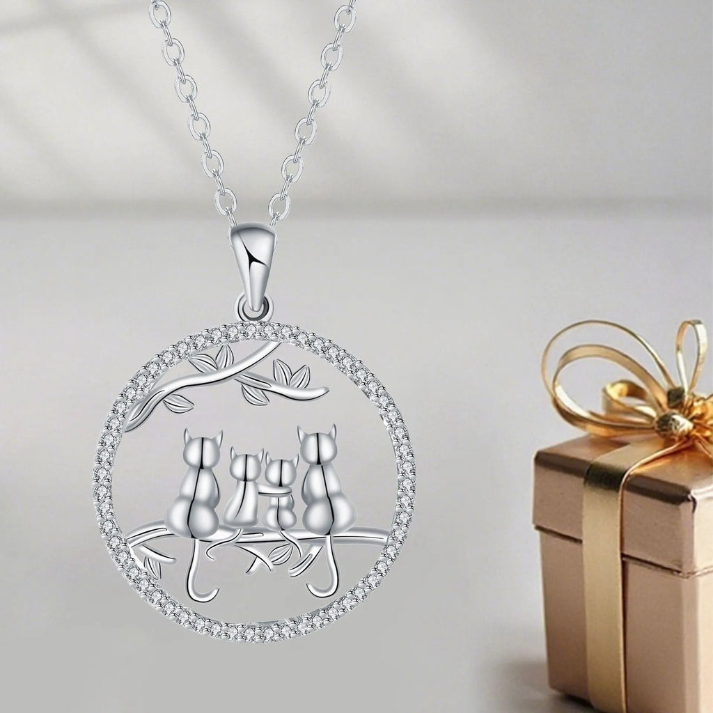 Close-up of a copper necklace featuring a pendant with four kittens in an original design, on a cross chain.