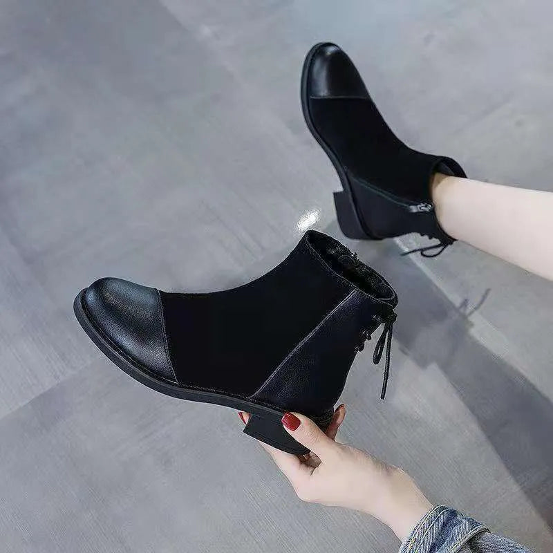 Black women's knee-high Martin boots with side zip, bow detail, and a round toe on a non-slip rubber sole.