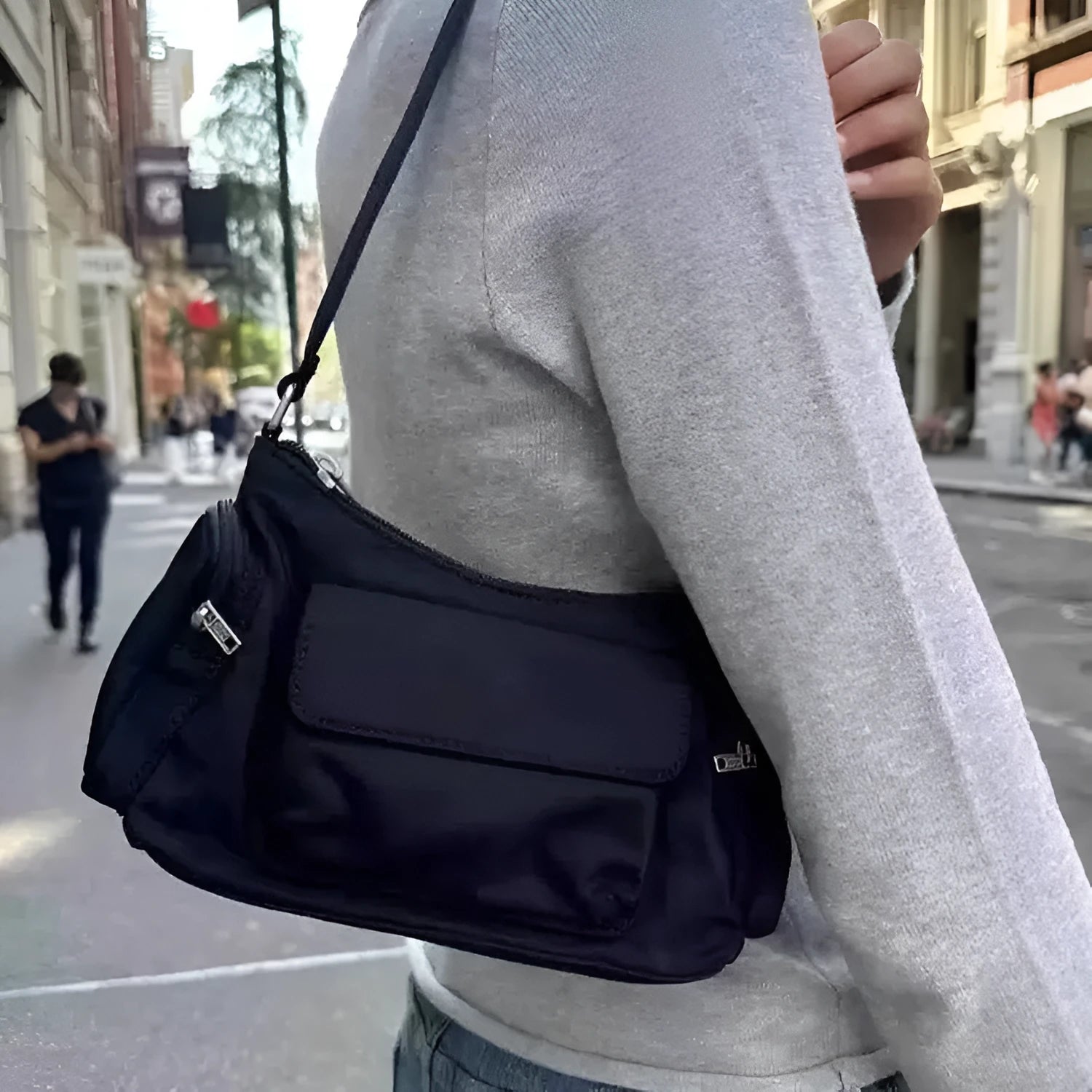Simple black lightweight women's PU shoulder bag with two front pockets and side line detail.