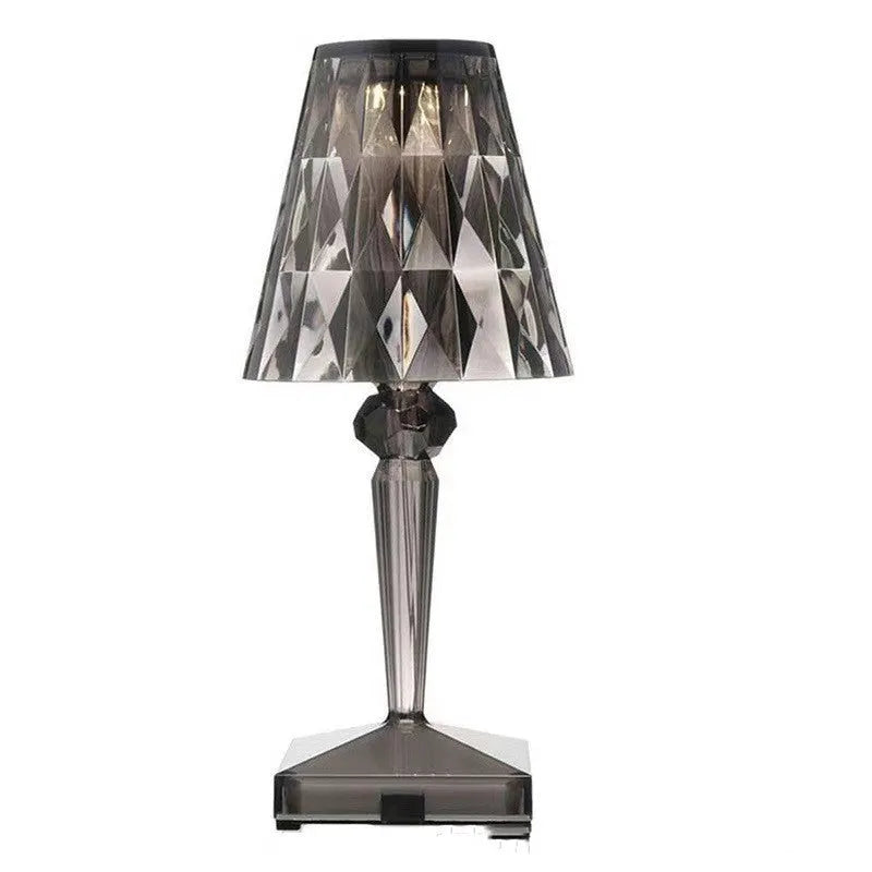Rose gold plated portable touch control LED night light with acrylic shade on a table.