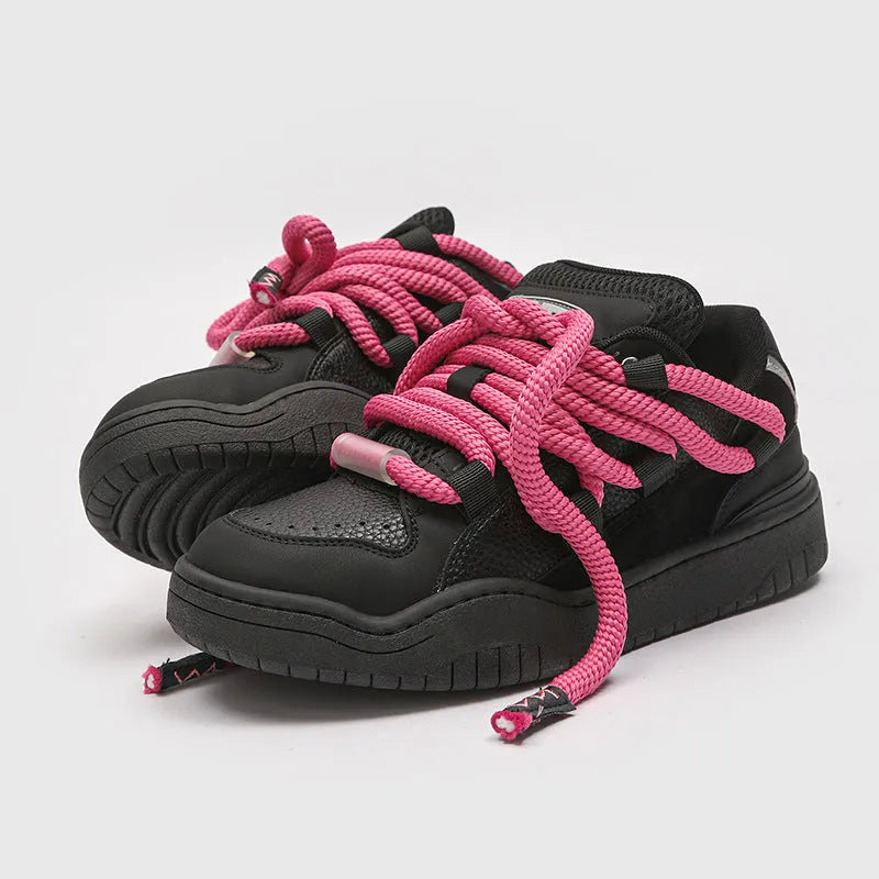 A pair of low-top unisex casual shoes with a round toe, thick rubber sole, and lace-up front on a white background.