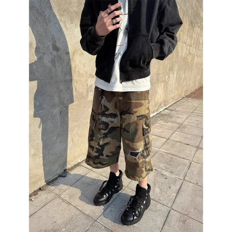 Men's loose-fit camouflage cropped jeans with ripped knees and retro patches on a straight-leg.