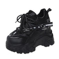 White and black women's low-top platform sports shoes with mesh upper and cross strap.