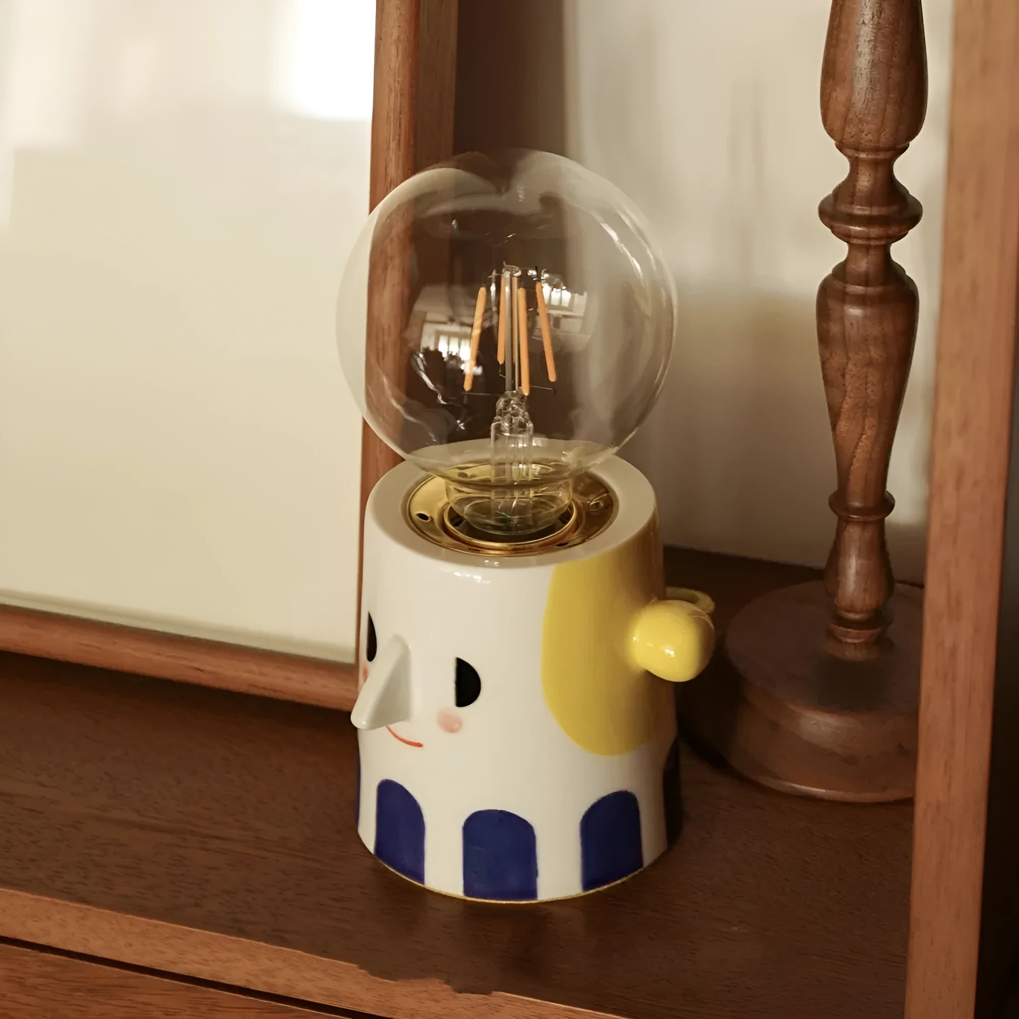 Handmade ceramic bedside lamp with ball headlight design in warm white colour