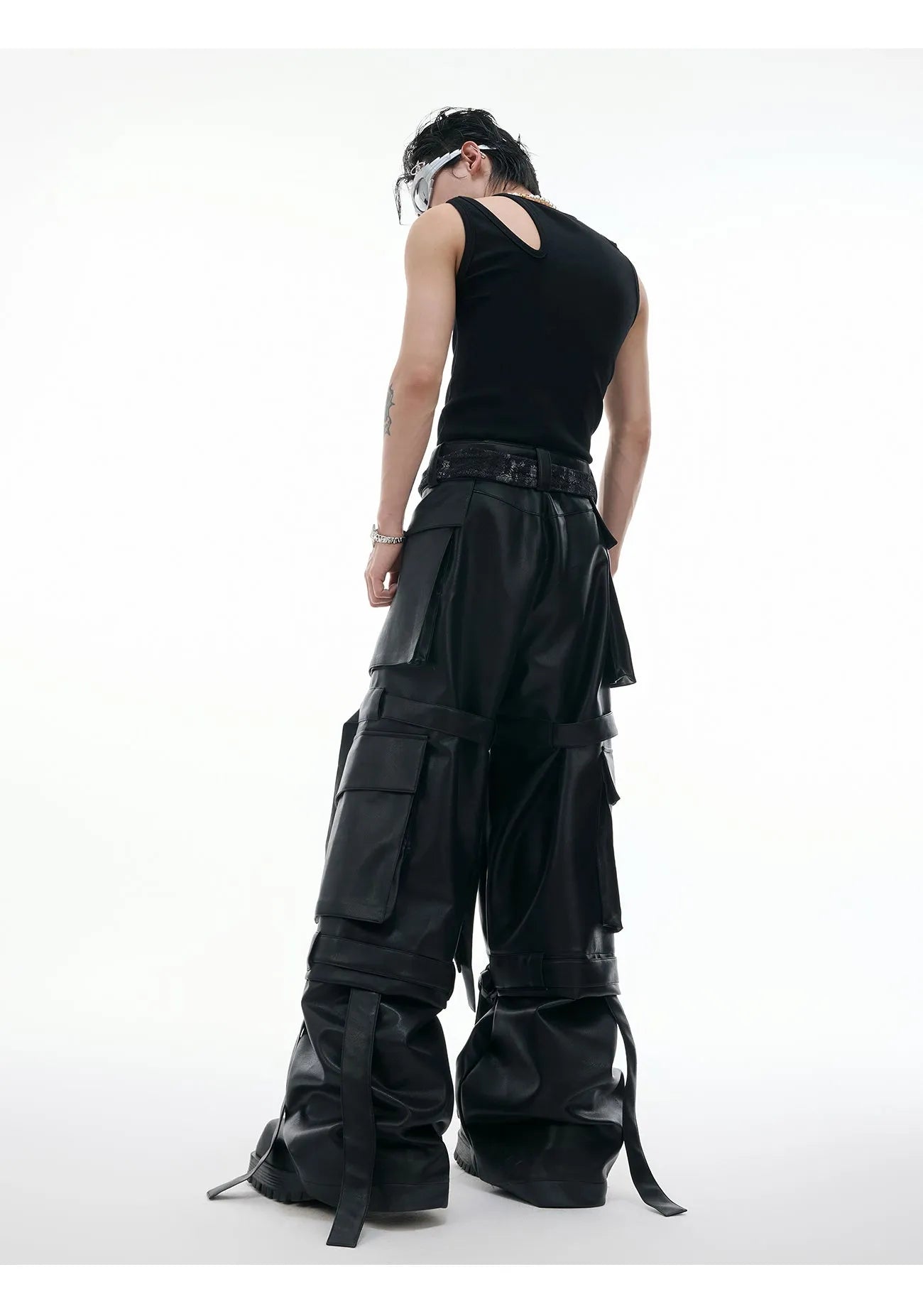 Black men's retro multi-pocket leather trousers with quilted stitching and loose fit.