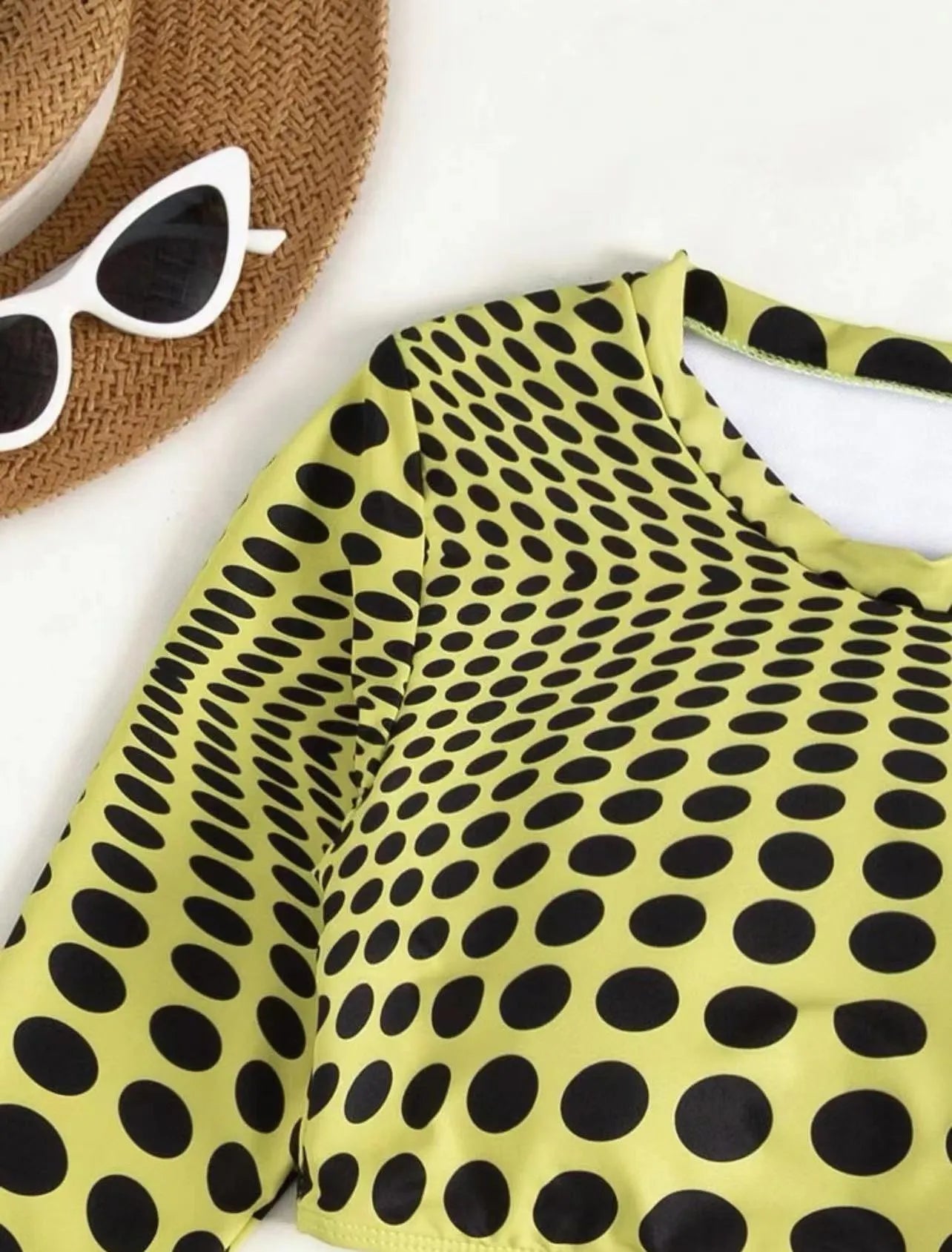Women's green polka dot three-piece swimsuit set with top, skirt, and bra