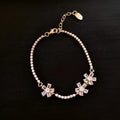 Geometric copper bracelet for women with quadrilateral pattern and inlaid zircon details in bracelet-gold colour.