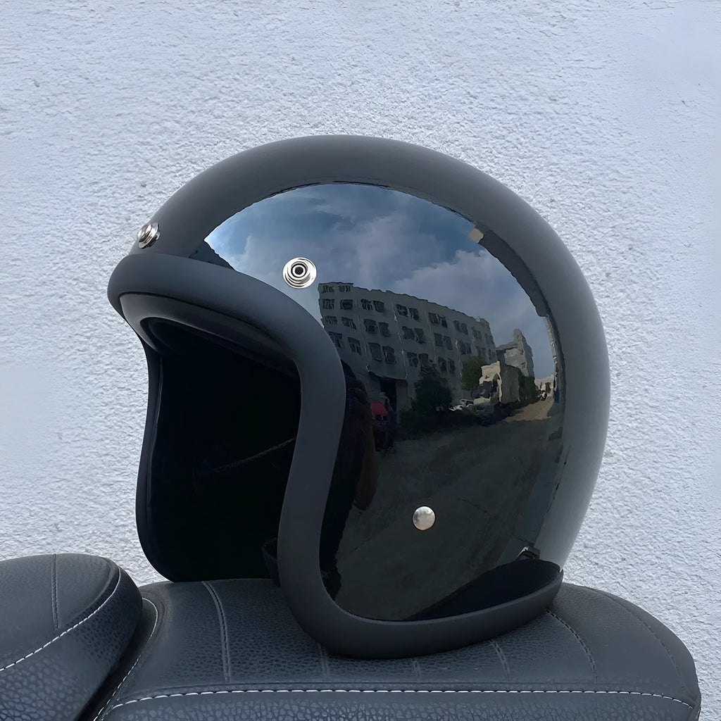 Glass fibre motorcycle half helmet in retro style shown in cement grey colour