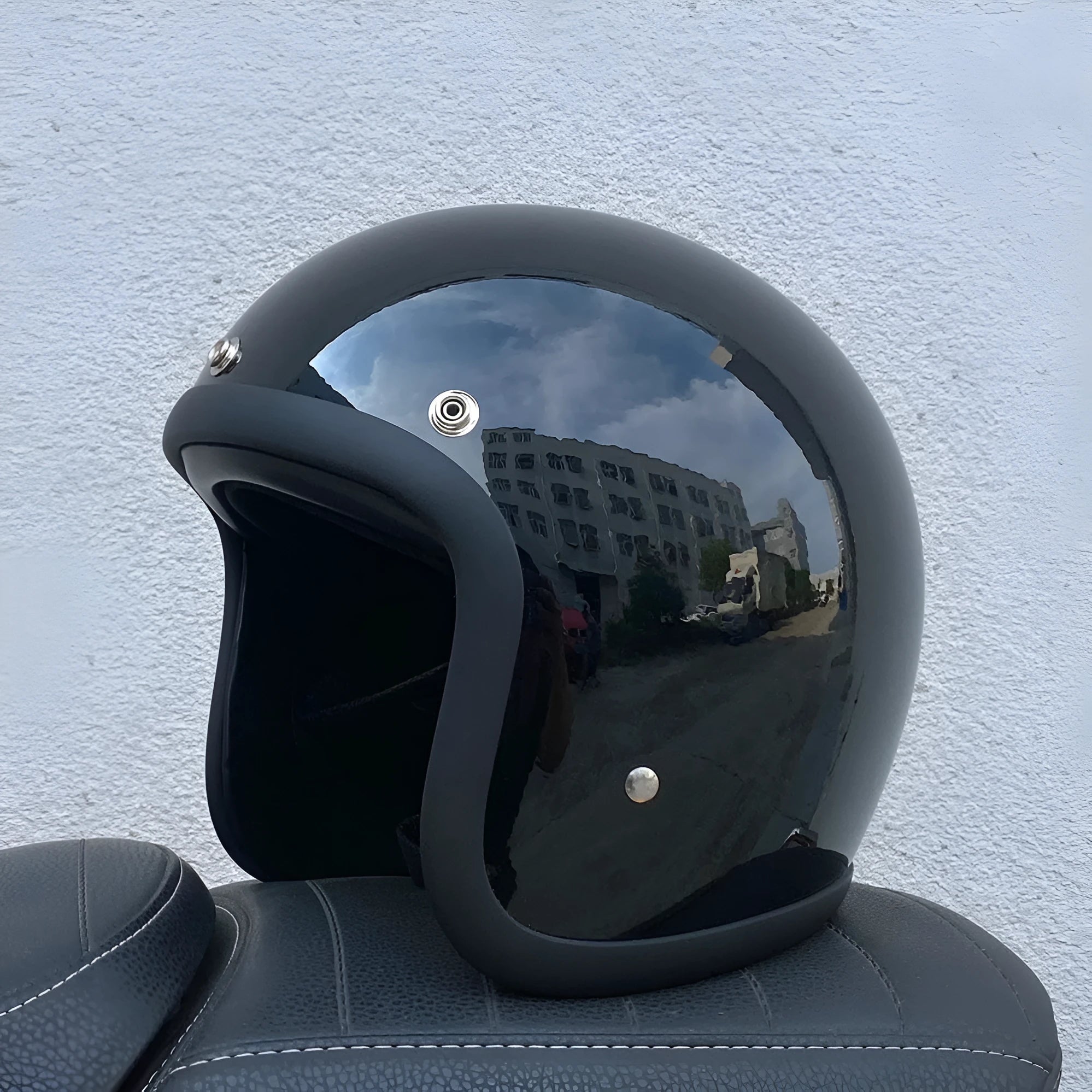 Glass fibre motorcycle half helmet in retro style shown in cement grey colour