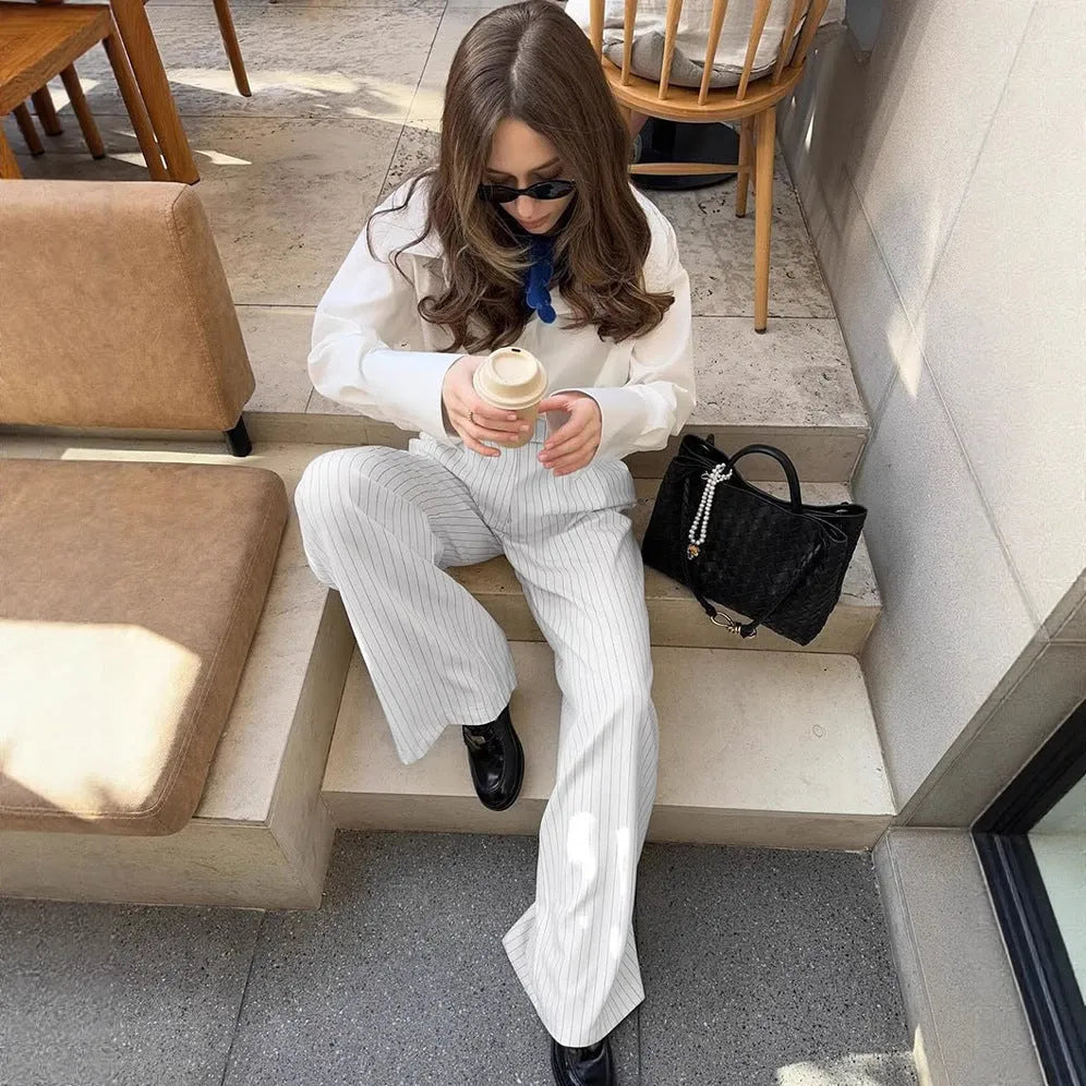 White striped wide-leg casual trousers with zipper closure on mannequin