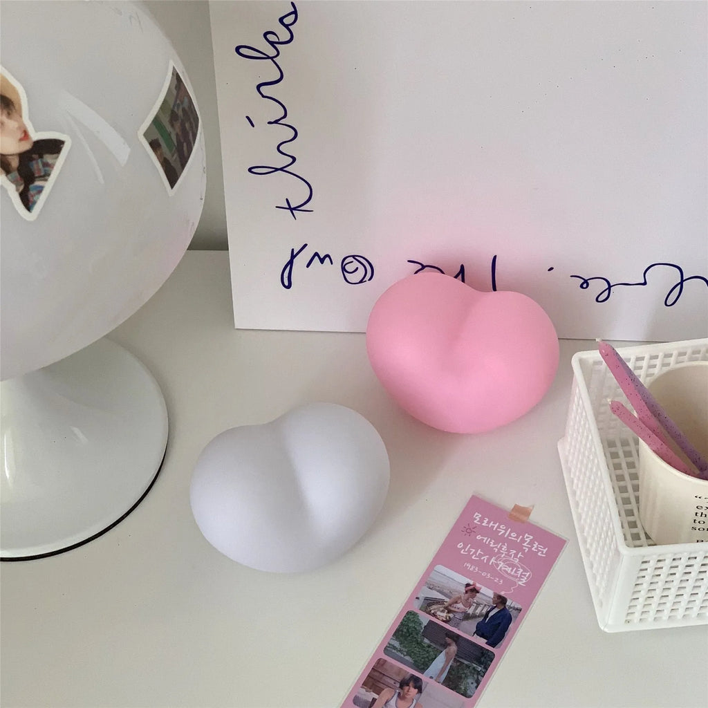 White or pink vinyl atmosphere lamp emitting warm light, shown in small and large size options.