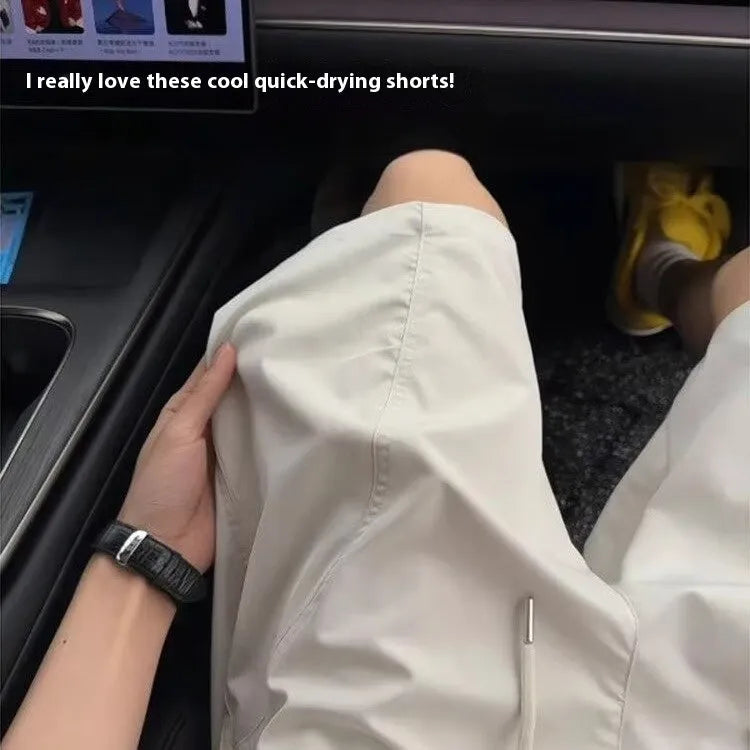 Men's quick-drying polyester sports shorts with slanted pockets in creamy-white, straight-leg design for summer