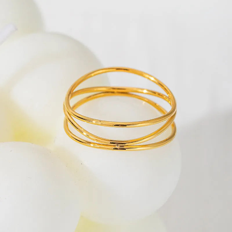 Gold geometric line ring with three-layer coil design in titanium steel
