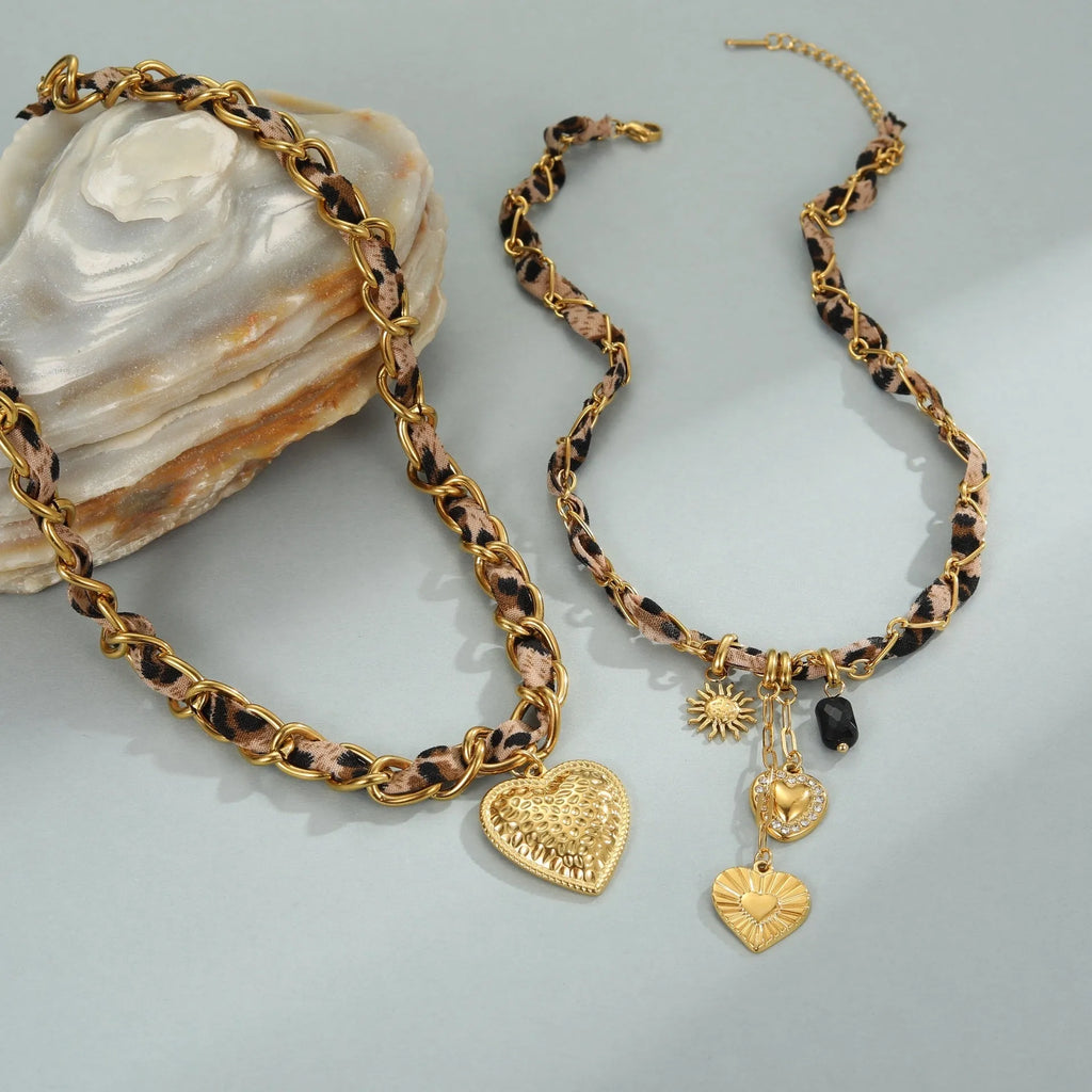 Geometric leopard love pendant on adjustable stainless steel necklace chain with gold-toned finish
