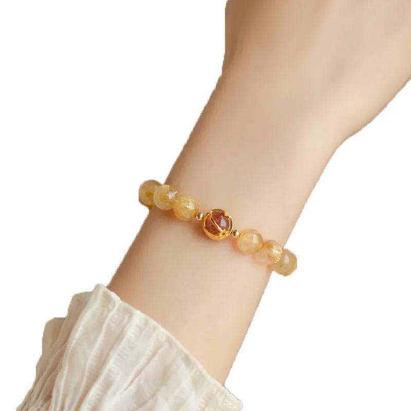 Natural citrine gold rutilated quartz diamond cut bracelet 6mm beads on neutral background