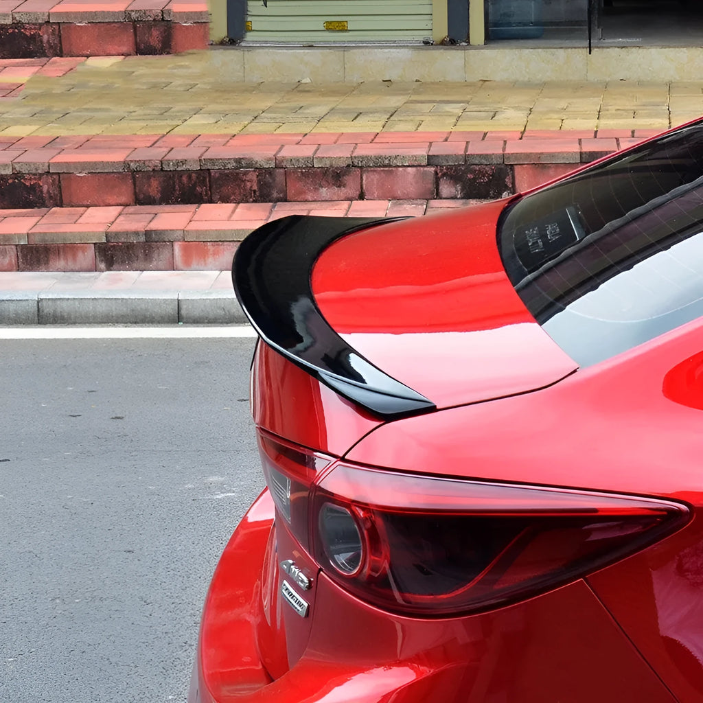 Bright black Mazda 3 Axela Exela tail trim for 2014-2021 models showing sports tail blade design