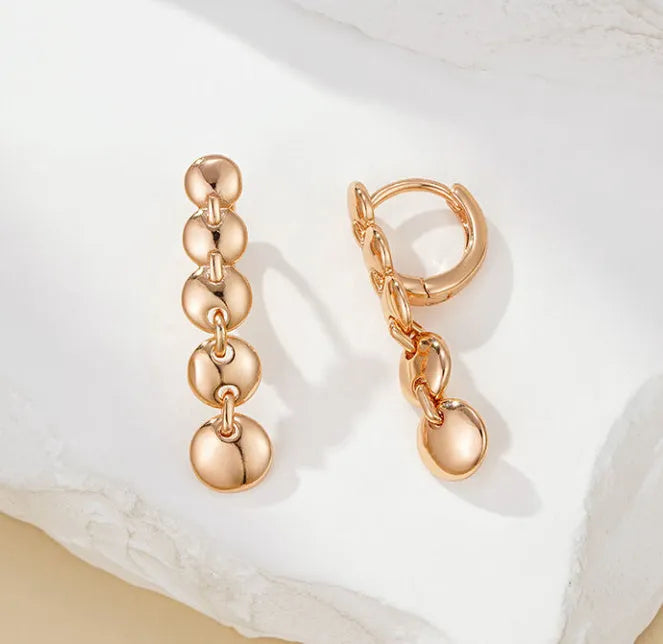 Gold retro long round circle drop earrings with woven wire construction.