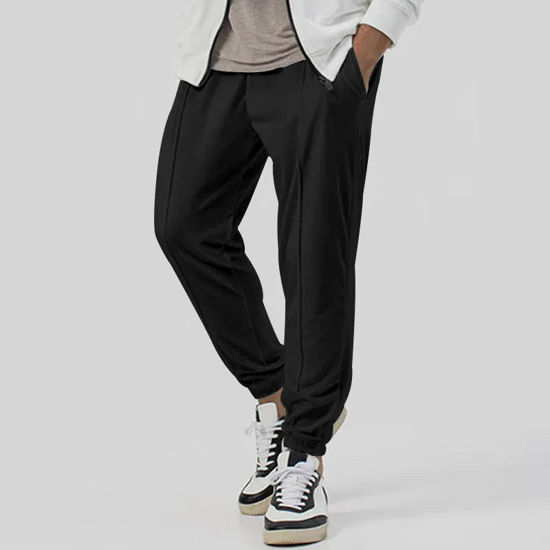 Men's gray loose fit tapered casual sweatpants with elastic waistband on a neutral background.