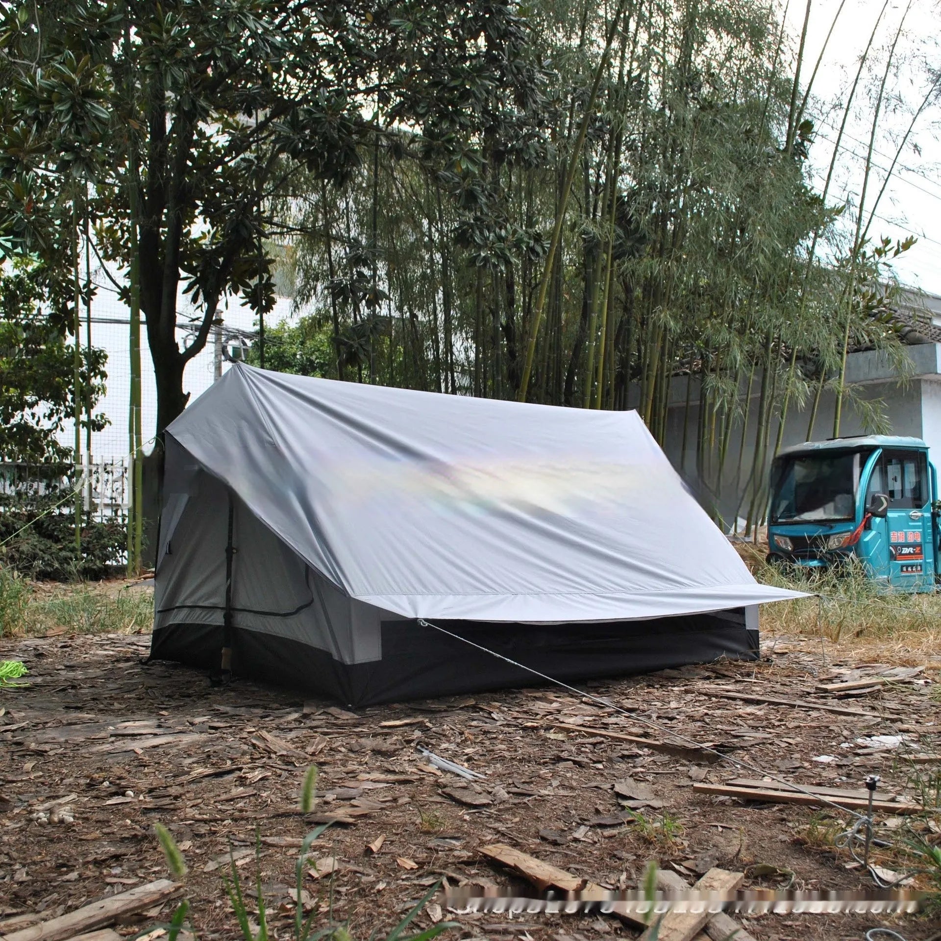 Brown or white A-line pole-free tent pitched with hiking canes showing 210x150x110cm dimensions
