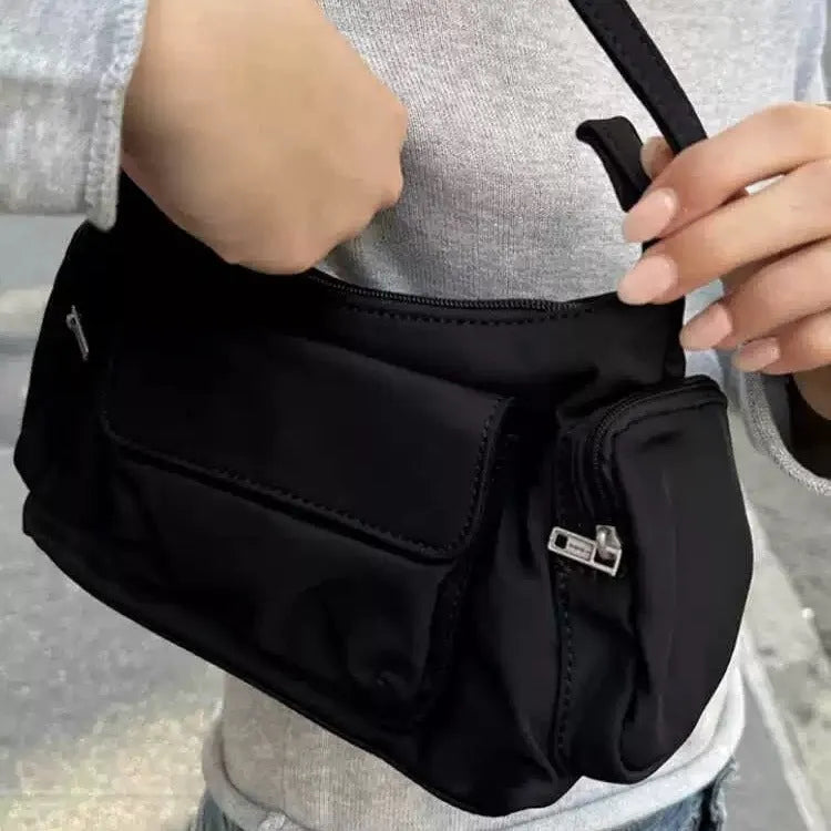 Simple black lightweight women's PU shoulder bag with two front pockets and side line detail.