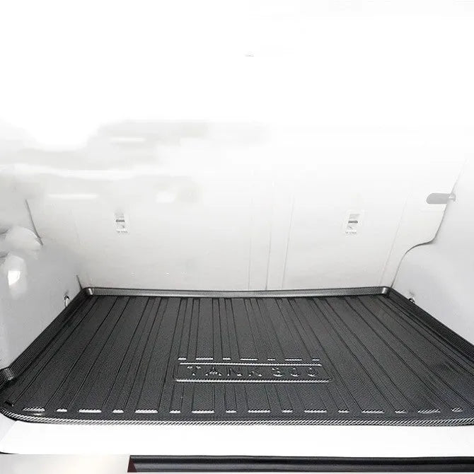 Black carbon fibre pattern TPE boot liner for a Special Car, showing textured surface and custom fit.