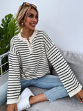 Women's black and white striped loose top with drop-shoulder sleeves and button details