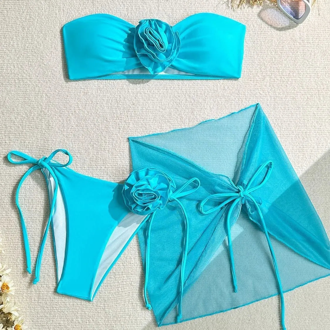 Women's pink tube top swimsuit with large 3D flower tie, matching skirt and bottom.