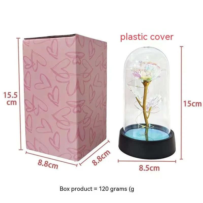 Small plastic night lamp with glass cover and plastic flowers, showing coloured LED light option.