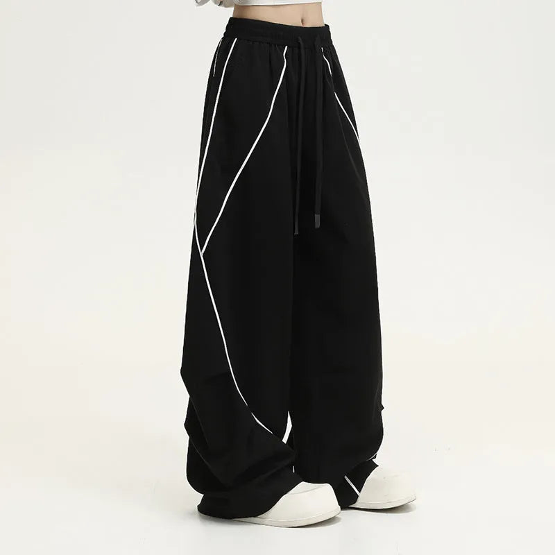 Black pleated wide-leg hip hop sports trousers with a striped pattern.