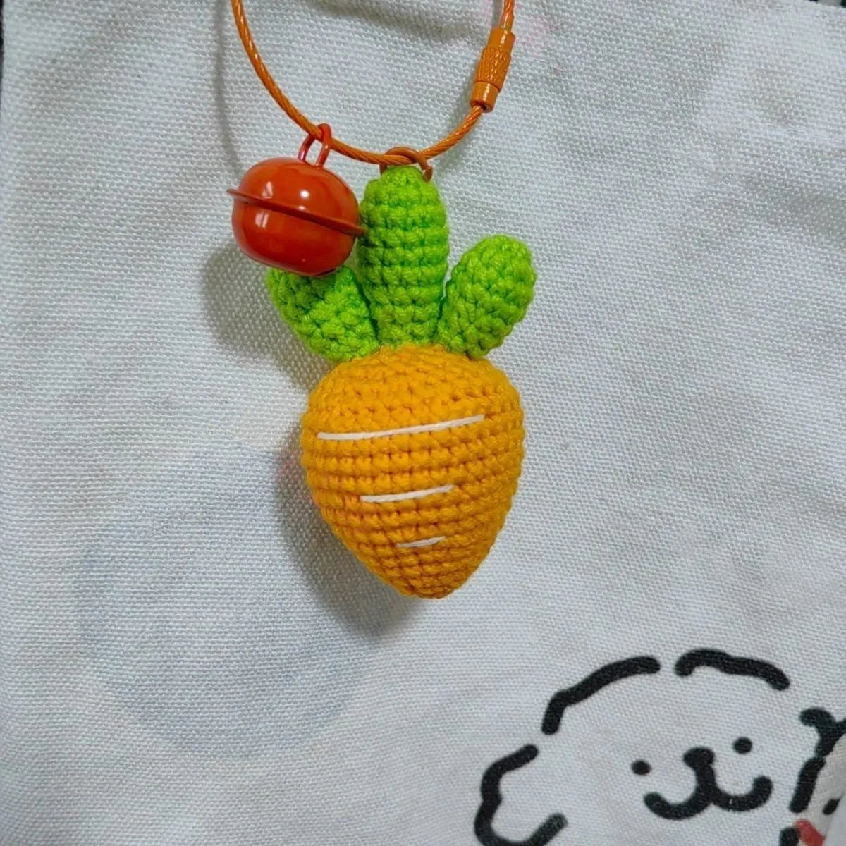 Orange and green carrot keychain pendant made from wool, shown on a key ring