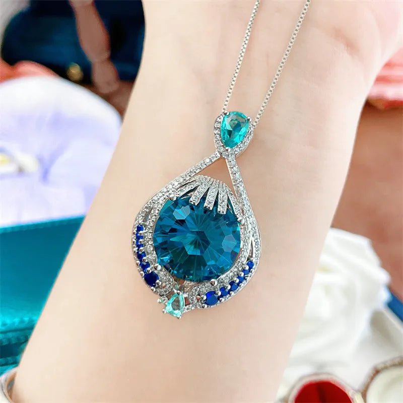 Blue fireworks-cut gem geometric pendant necklace on water wave chain for women