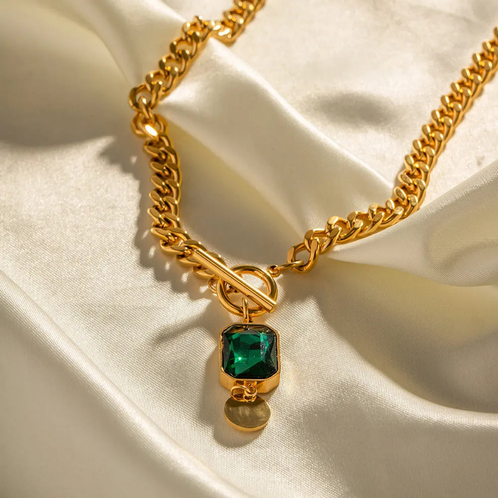 Gold-coloured geometric round zircon pendant necklace with a titanium steel Cuban link chain.