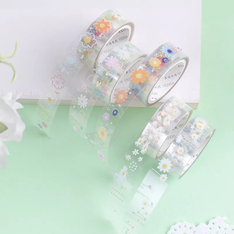 Five rolls of transparent adhesive tape with yellow and white daisy cartoon pattern on a clear background.