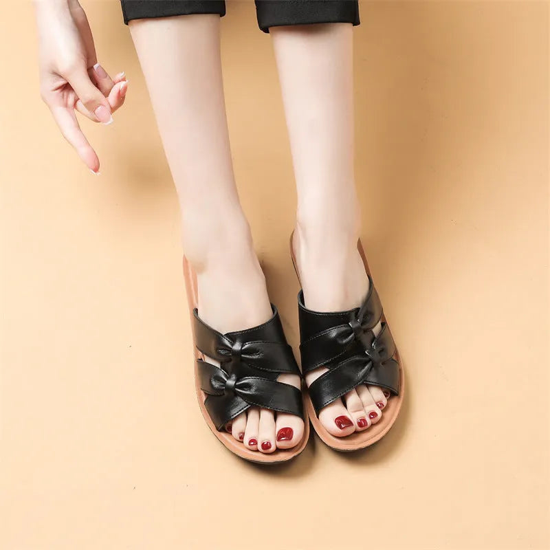 Women's cowhide leather soft bottom non-slip slippers in beige, black, and red colours on a light background
