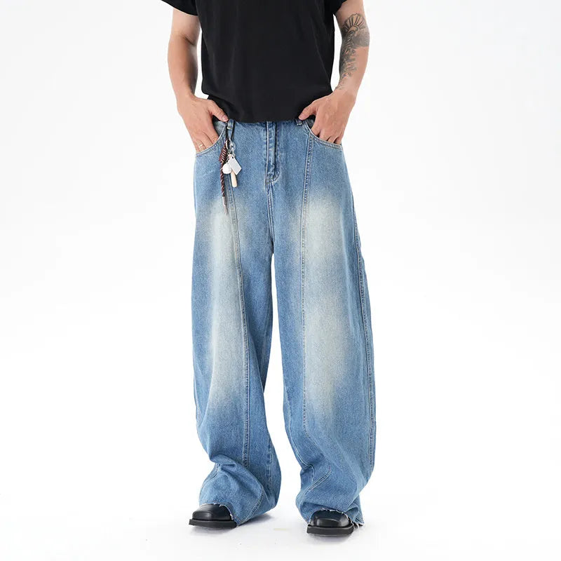 Cut washed vintage washed wide leg machete jeans in light blue denim with zipper fly, front view