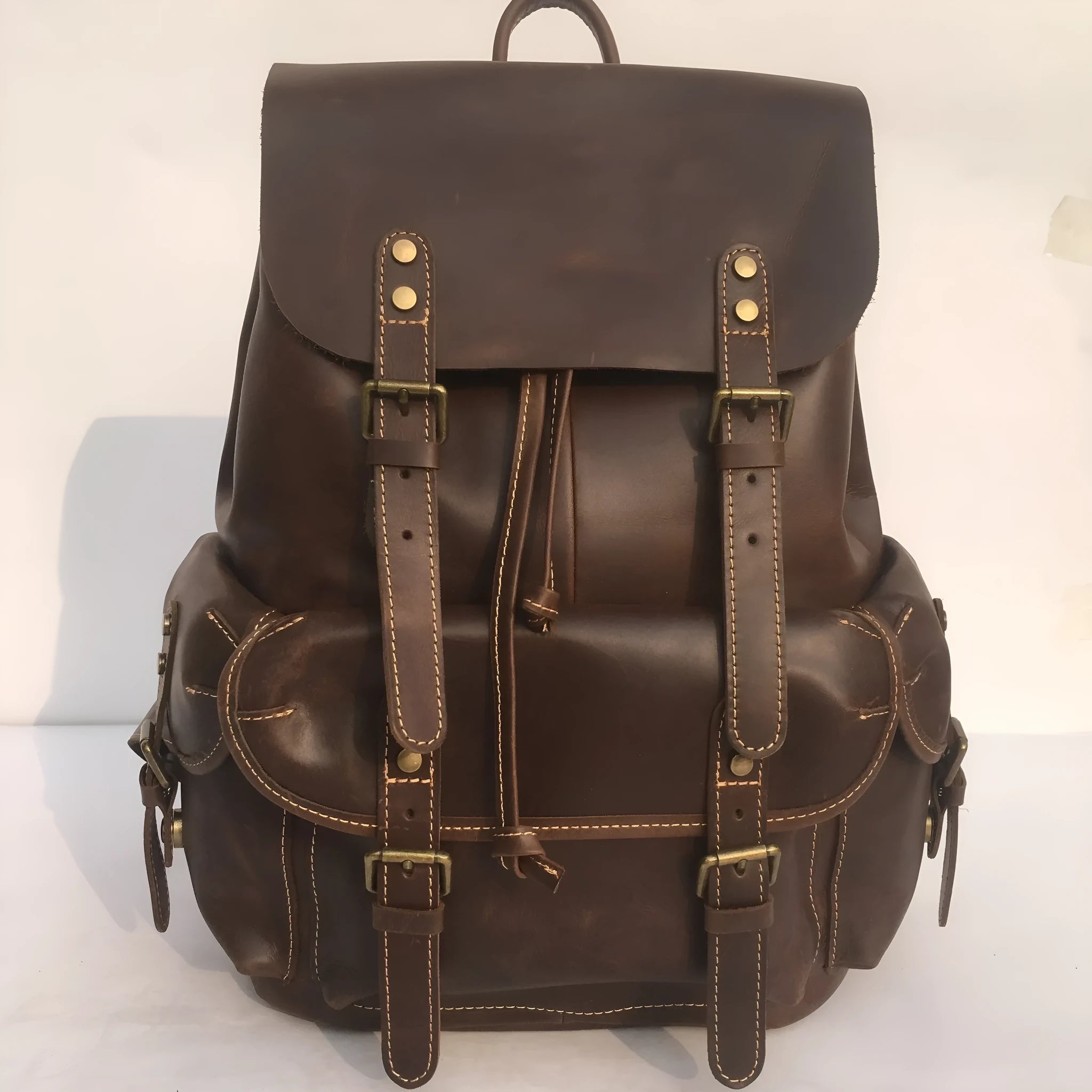 Men's genuine top layer cowhide leather backpack in coffee brown with air pillow belt, front view