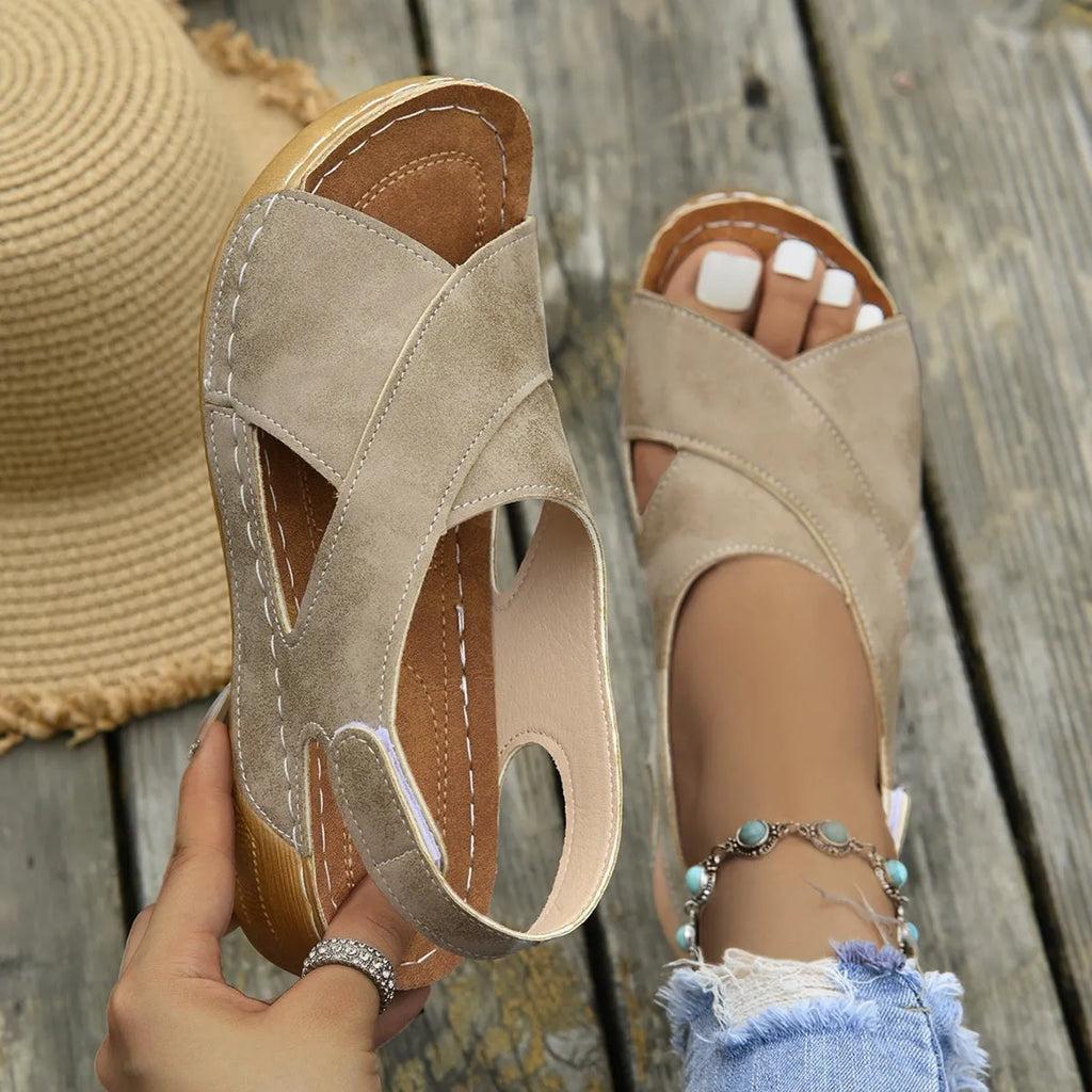 Women's brown platform Roman sandals with Velcro strap closure and open toe design