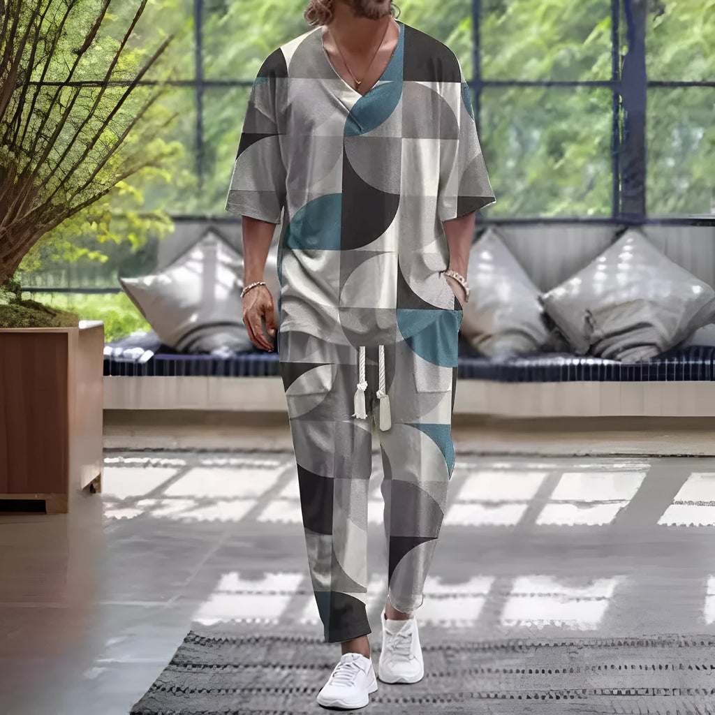 Man wearing a light grey cropped sleeve V-neck jacket and matching trousers from a two-piece suit