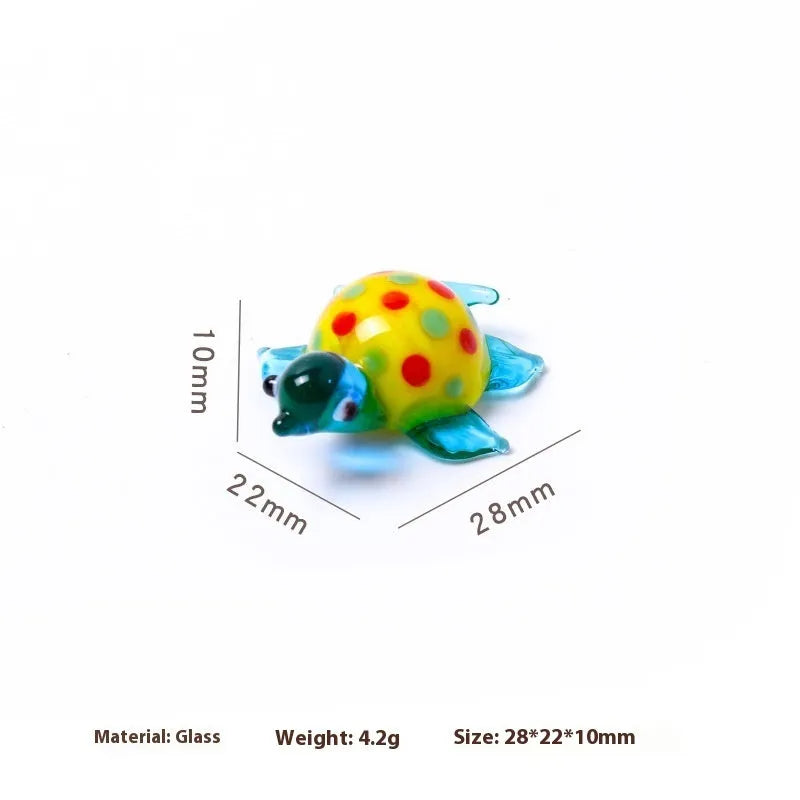 Geometric glass turtle ornament in a modern style displayed on a wooden surface.