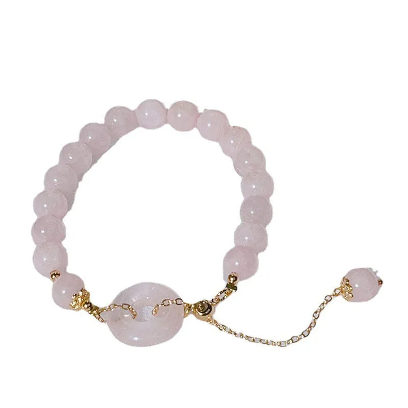 Crystal safety buckle bracelet for women in pink with peace buckle design on white background