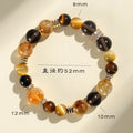 Close-up of a women's bracelet with yellow tower-shaped artificial crystal beads on a string.