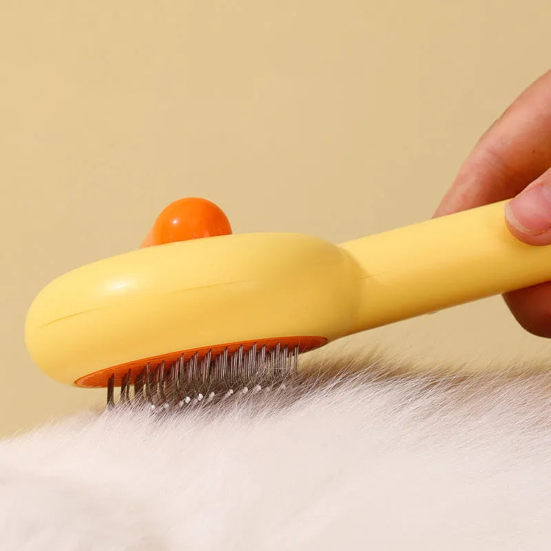 Small yellow duck-shaped pet comb for cat and dog grooming with needle teeth