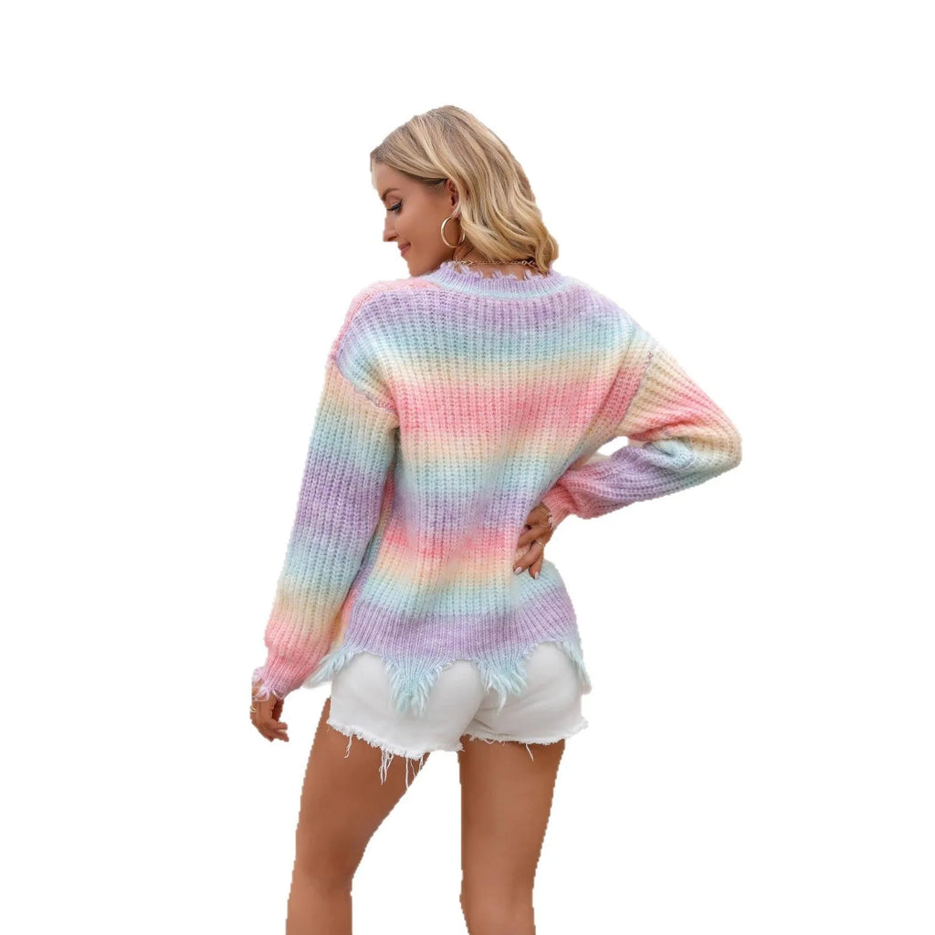 Pink loose cut rainbow gradient knitted sweater with tassels on a hanger